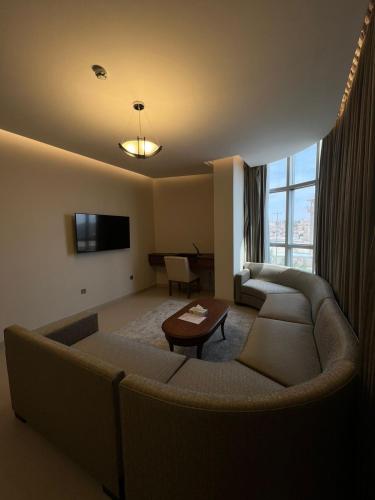 a living room with a couch and a table at فندق الضليعة in Unayzah