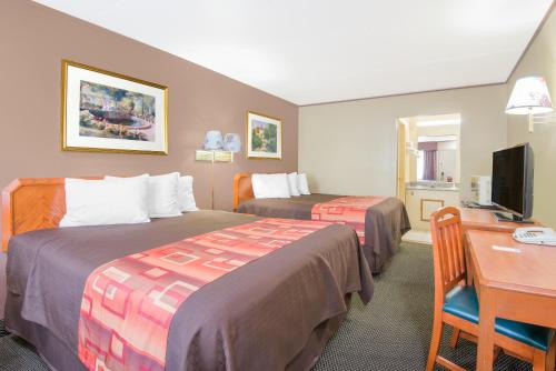 una camera d'albergo con 2 letti e una scrivania di Travelodge by Wyndham Mansfield a Mansfield