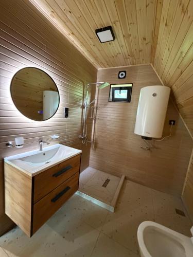 a bathroom with a sink and a mirror at Horizon Mestia - Premium Chalets With Panoramic Views in Mestia