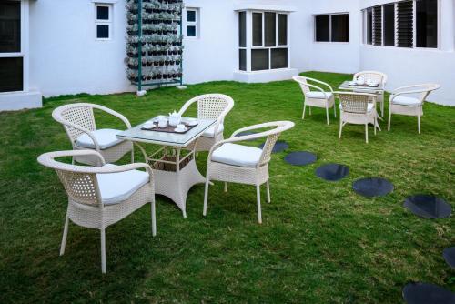 a group of tables and chairs on the grass at Fiestaa Resort n Events Venue in Devanahalli-Bangalore