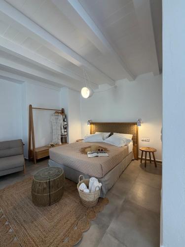 a bedroom with a large bed and a couch at Blue Paradise Apartments in Naxos Chora