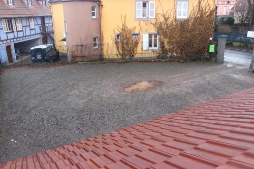 an empty yard with a house and a driveway at A la Maison Rouge Hôtel & Restaurant in Barr