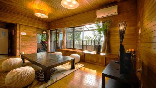 a living room with a table and a window at Balistyle Tateyama View in Tateyama