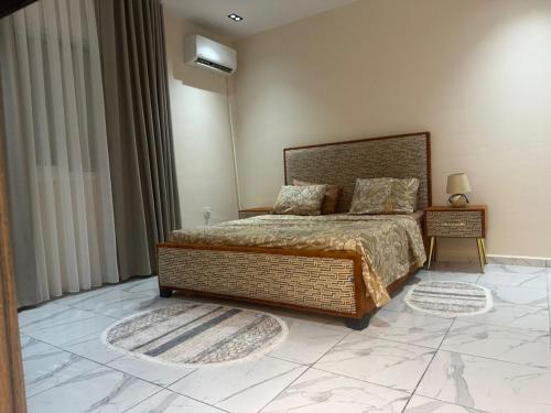 a bedroom with a large bed and a nightstand and a bed sidx sidx sidx at Tarek in Oran