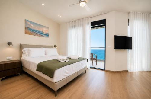 a bedroom with a bed with a view of the ocean at Rajna Apartments in Ulcinj