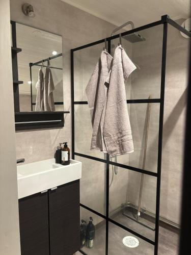 a bathroom with a sink and a shower with towels at Dockstavägen 7 in Docksta