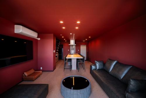 a living room with a couch and a table at THE SECOND Chousei Beach Village in Jōnouchi