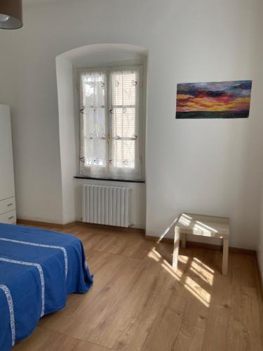 a bedroom with a bed and a window and a table at Il Sogno di Giorgio in Chiavari