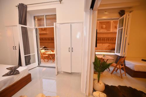 a small room with a bed and a table at suites in cairo downtown in Cairo