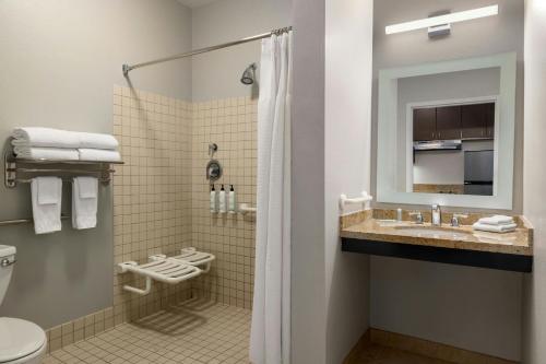 a bathroom with a shower and a sink and a toilet at TownePlace Suites by Marriott Phoenix Goodyear in Goodyear