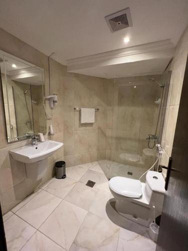 a bathroom with a toilet and a sink at Al Muhaidb Residence Holiday Homes Al Hada Resort - Economic in Al Hada