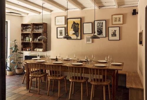 a dining room with a large wooden table and chairs at Historic Brewery Cottage in Dorset Village Sleeps 10 in Fontmell Magna