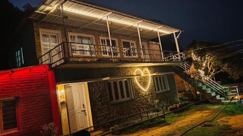 a building with a clock on the side of it at night at Emerald home stay in Kodaikānāl