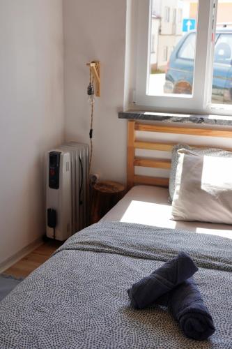 a bedroom with a bed with a hat on it at Toca da raposa in Raposeira