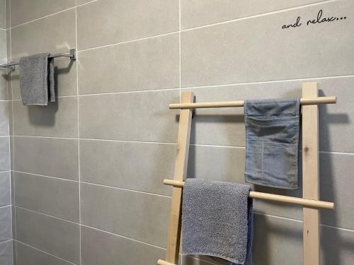 a bathroom with a towel rack with blue towels at Apartments No26 in Povile