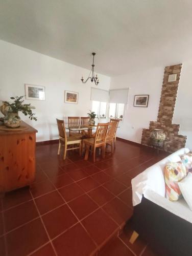 a living room with a dining room table and chairs at Chalet Matalascañas in Matalascañas