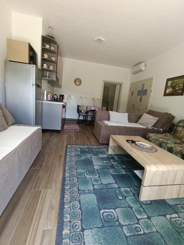 a living room with a couch and a table at Apartman Una na dlanu, Novi Grad in Bosanski Novi