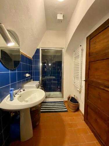 a bathroom with a sink and a shower at Fortress overlooking the sea in Porto Ercole