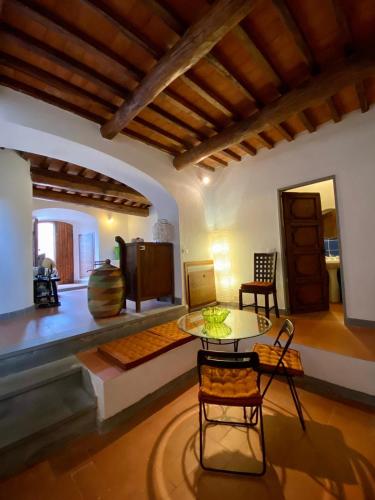 a living room with a table and chairs at Fortress overlooking the sea in Porto Ercole