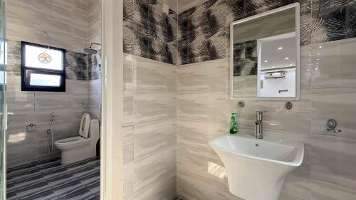 a bathroom with a sink and a toilet at Villa Berka in Barka