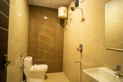 a bathroom with a toilet and a sink at Magnet Hotel in Vijayawāda