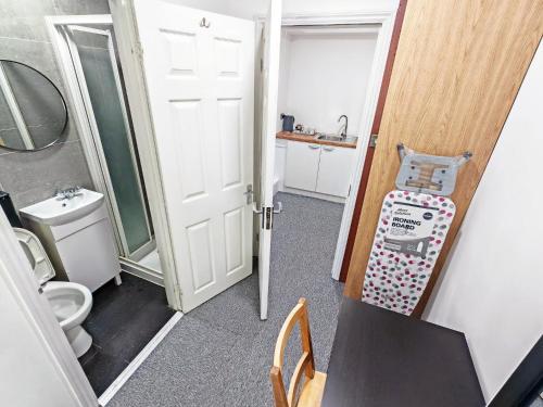 a small bathroom with a toilet and a sink at Hawthorn Studio - Self Contained One-Bed Studio Flat in Oxford