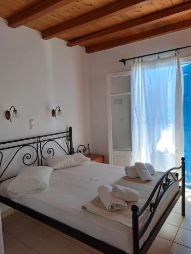 a bedroom with a bed with two towels on it at Hotel Posidonion in Koufonisia