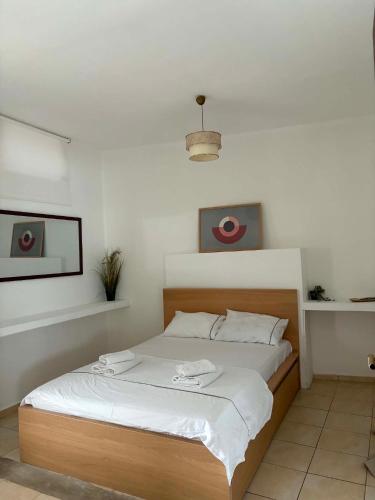 a bedroom with a large bed with white sheets at Popi's Apartment in Goníai