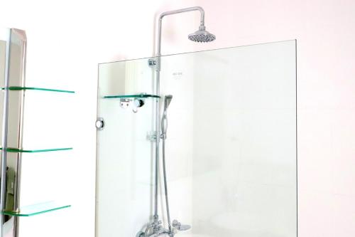 a shower with a glass door in a bathroom at The Olive Edit in Batemans Bay