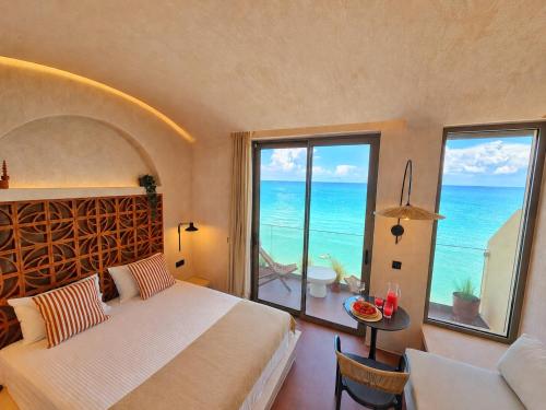 a bedroom with a bed and a view of the ocean at Ca' Mare luxury suite in Mesongi