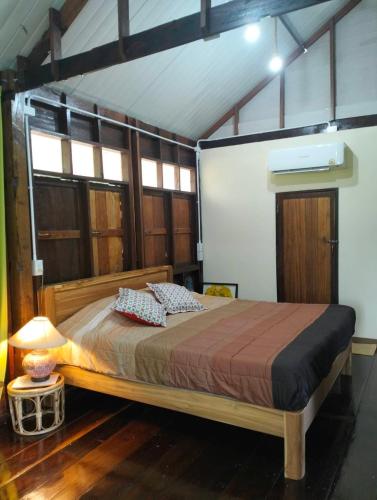 a bedroom with a large bed in a room at Tamarind nest in Sai Yok
