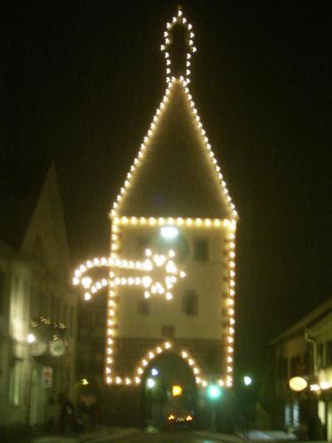 a building decorated with lights in front of a building at TIPTOP Hotel Garni Pfauen in Endingen