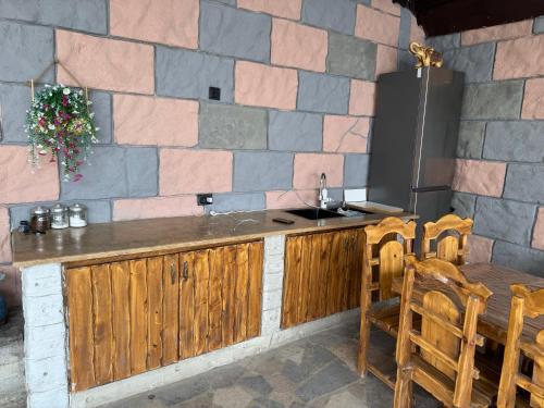 a kitchen with a counter and a table and chairs at Дом с бассейном в Ереване in Davitashen