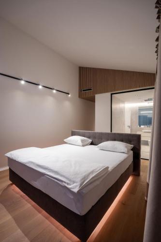 a bedroom with a large bed with white sheets at Villa FUX Eternity 3 in Ždrelac