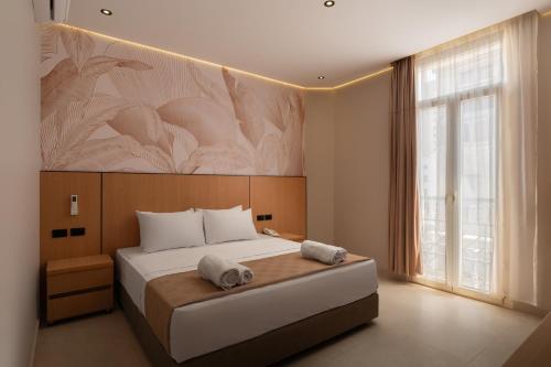 a bedroom with a large bed with a large painting on the wall at Royal Hotel in Cairo