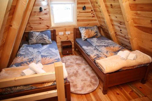 a bedroom with two beds in a log cabin at Zekova Valley Cabin Durmitor in Žabljak