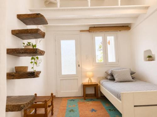 a bedroom with a bed and a window at The simple two-bedroom house at Klima Beach in Samos