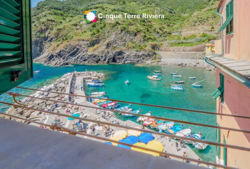 a view of a beach with boats in the water at Maemuna Sea View Apartment in Vernazza