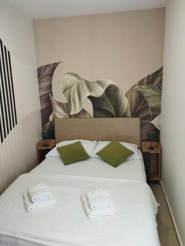 a bedroom with a bed with two towels on it at HN Lux & SPA in Veliko Gradište