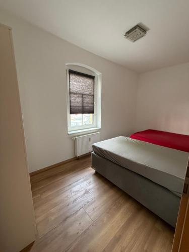 a white bedroom with a bed and a window at Cozy Room for 2 people in Dresden