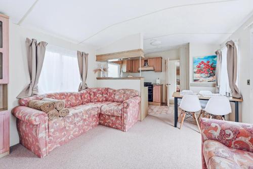 a living room with a couch and a table at Vagunmaja in Haapsalu
