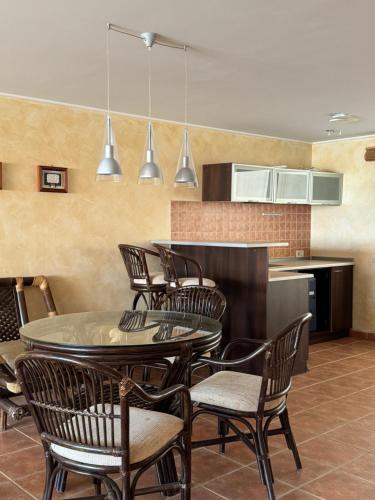 a dining room with a table and chairs and a kitchen at Двоповерхові апартаменти в яхт-клубі in Odesa