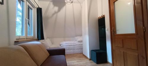 a living room with a couch and a window at Domek w Sielpi in Sielpia Wielka
