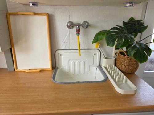 a kitchen sink sitting on a counter next to a mirror at Privatunterkunft Bingum in Leerort