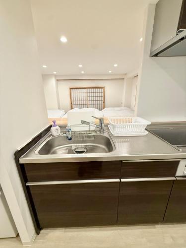 a kitchen with a sink in a room at Central Roppongi House in Tokyo