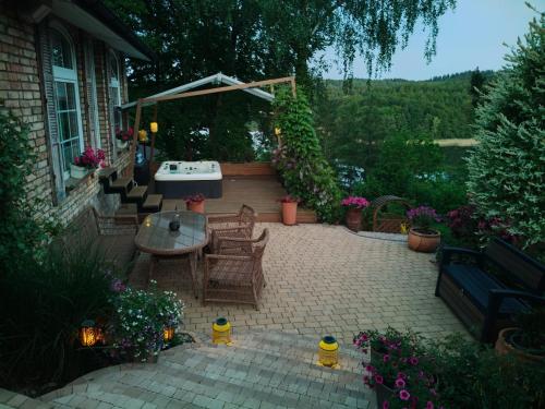 a patio with a table and chairs and a table at Mała Garda in Brodnica Dolna