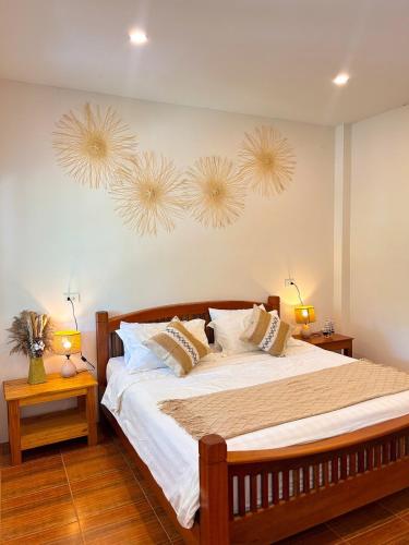 a bedroom with a large bed with two lights on the wall at Jungle Hideaway with Pool Wifi Smart TV in Ban Tai