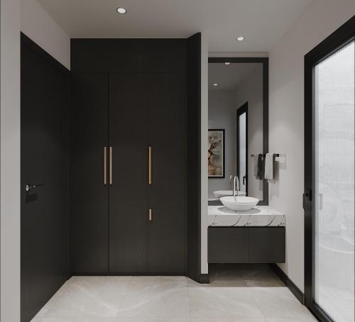 a bathroom with black cabinets and a white sink at Anvi Boutique Hotel Hanoi in Hanoi