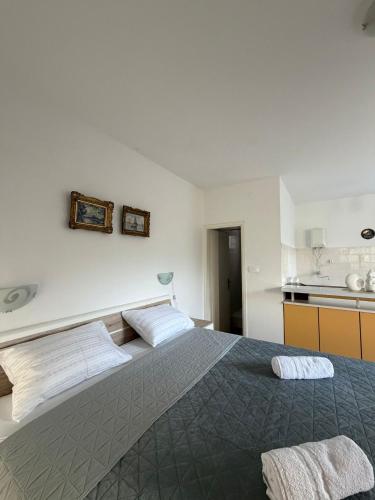 a bedroom with a large bed with two white pillows at Studio Apartman ISRA 1 in Palit