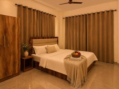 a bedroom with a bed with a bowl of fruit on a table at The Sanctuary in McLeod Ganj